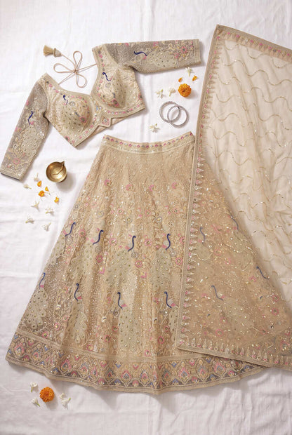 Elegant Floral Patterned Net Lehenga Set in Beige with Embellished Blouse and Dupatta with light gold colour.