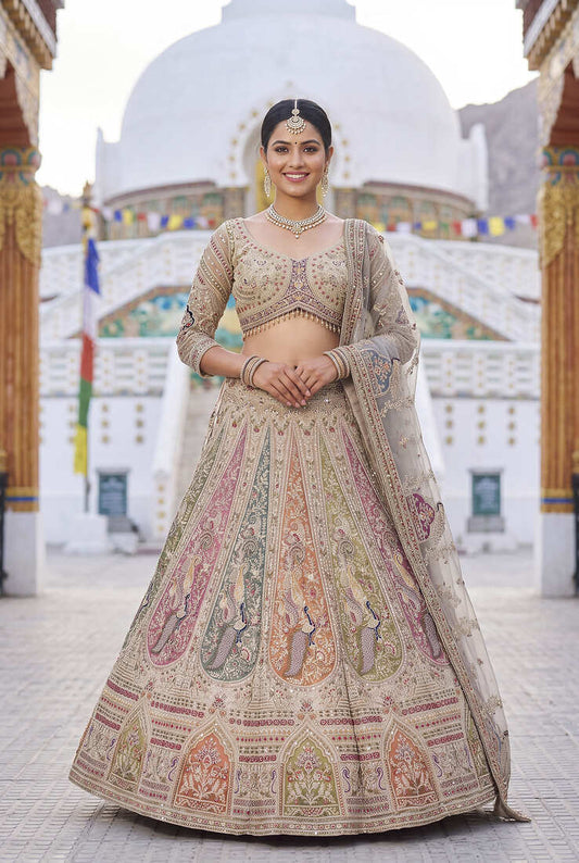 Elegant Beige Bridal Lehenga Set Featuring Traditional Peacock Motifs and Intricate Hand Embroidery