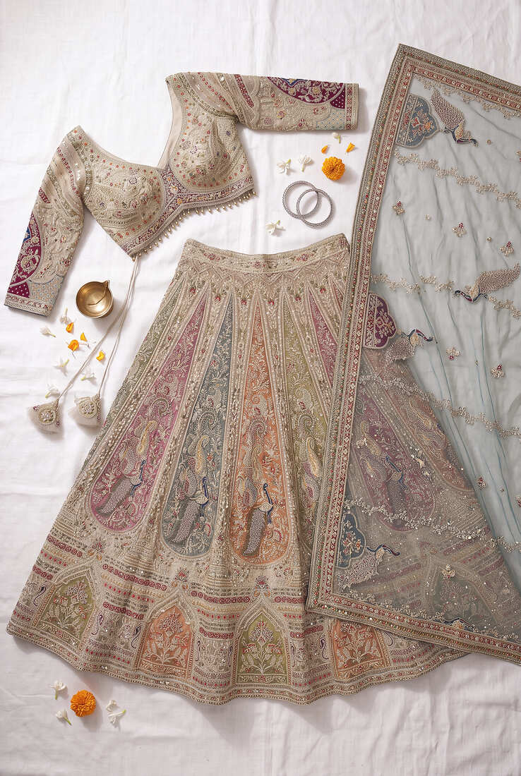 Elegant Beige Bridal Lehenga Set Featuring Traditional Peacock Motifs and Intricate Hand Embroidery