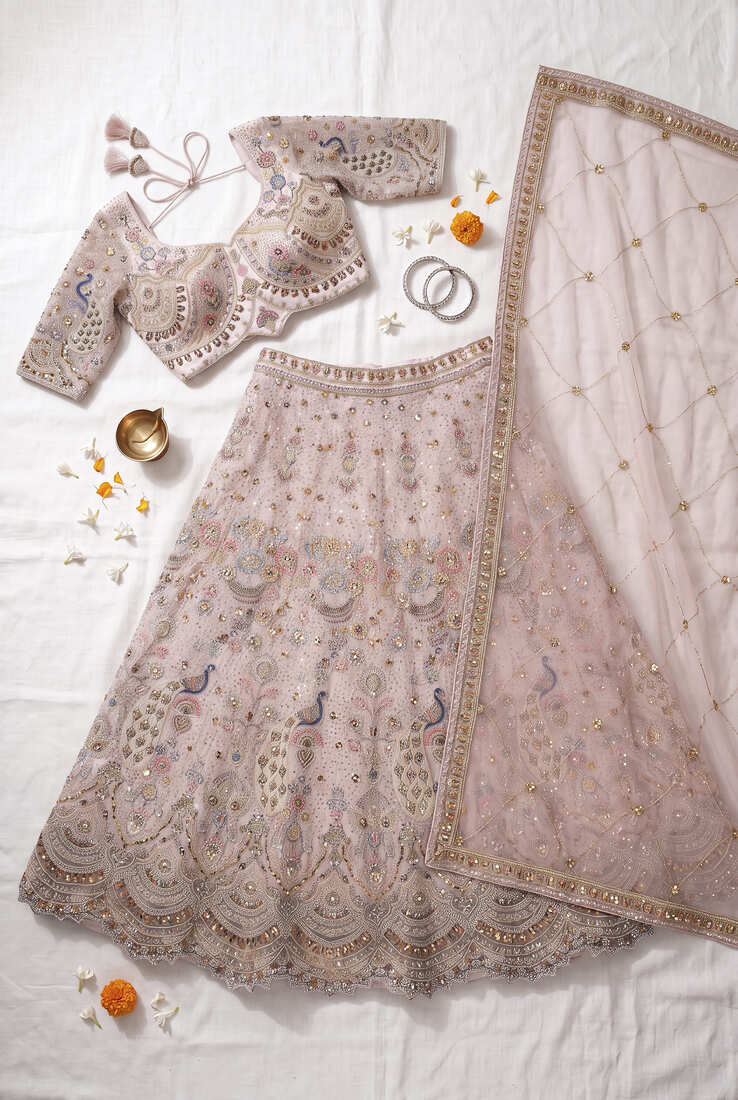 Designer Embroidered Pastel Pink Lehenga Choli Set with Peacock Motif and Net Dupatta for Wedding and Festive Wear