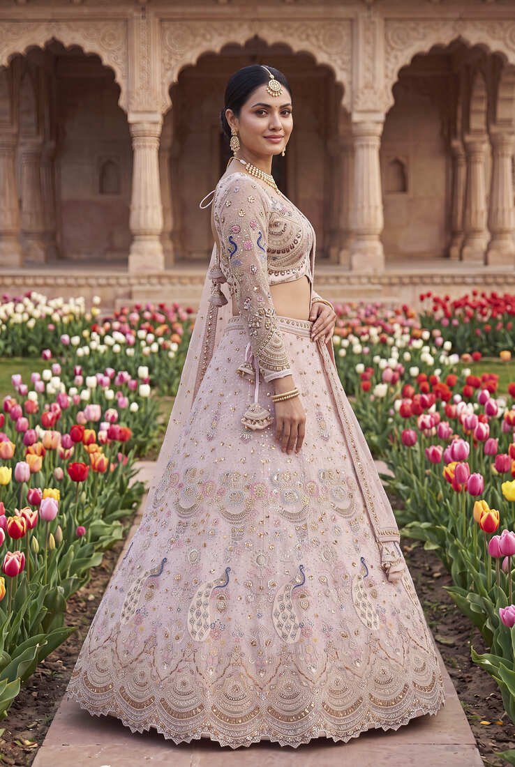 Designer Embroidered Pastel Pink Lehenga Choli Set with Peacock Motif and Net Dupatta for Wedding and Festive Wear