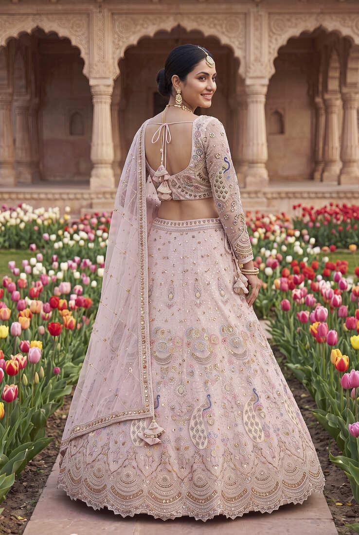 Designer Embroidered Pastel Pink Lehenga Choli Set with Peacock Motif and Net Dupatta for Wedding and Festive Wear